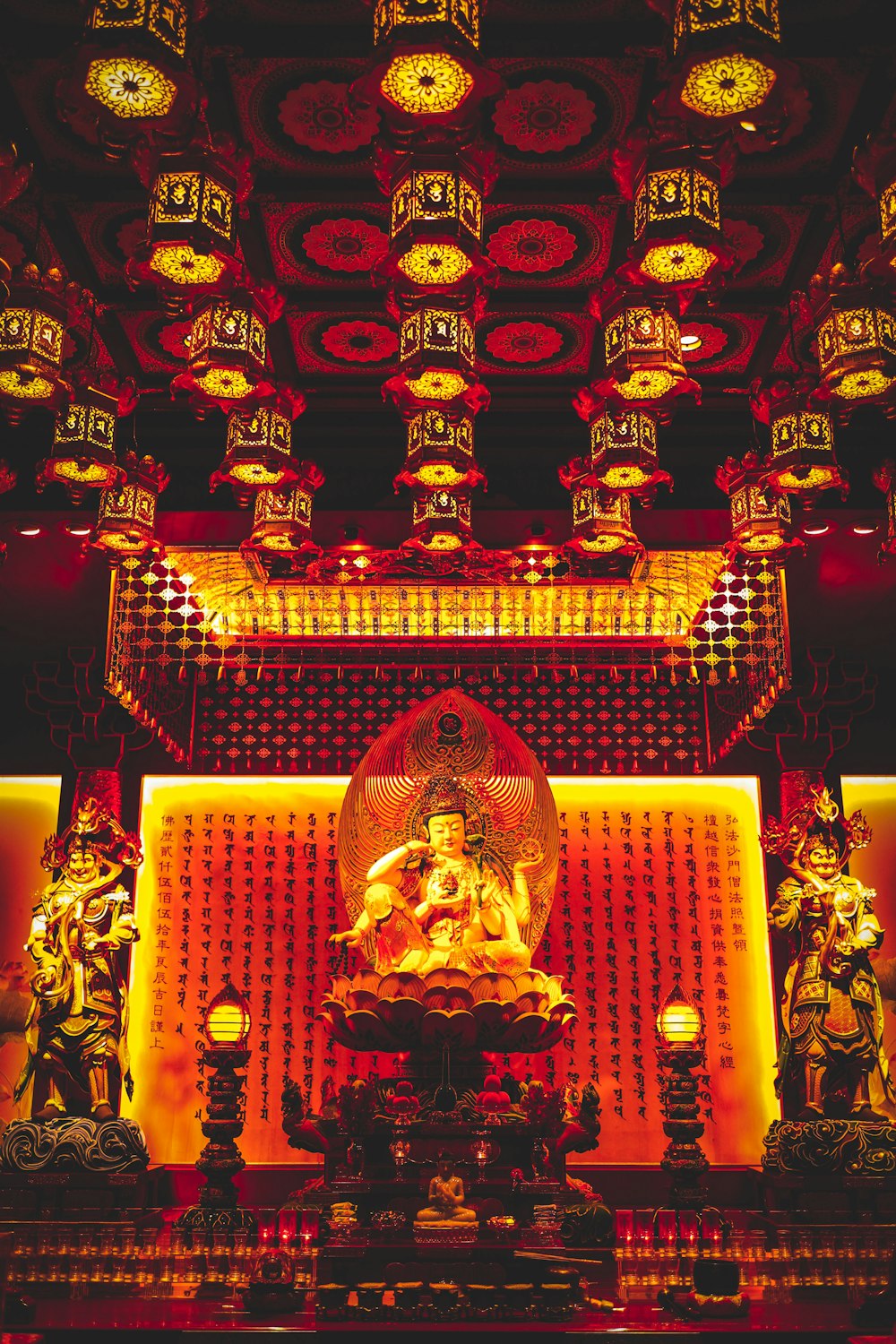 Buddha statues inside building with lights