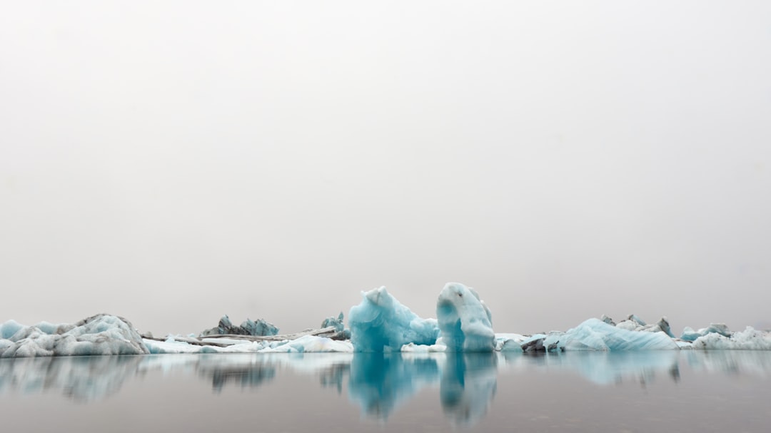 icebergs under gray sky at daytime