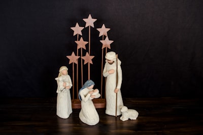 three religious figurines on brown surface nativity google meet background