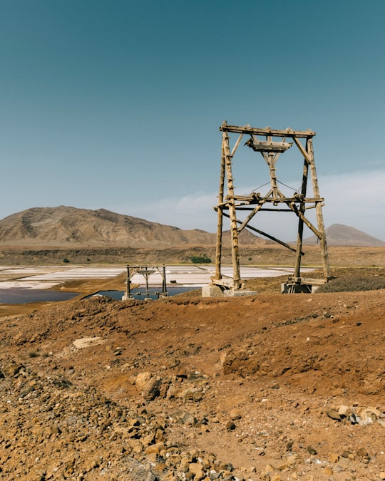 brown wooden tower near body of water during daytime in Pedra de Lume Cape Verde