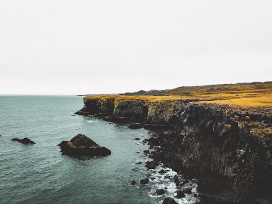 beach cliff viewing calm sea in Gatklettur Iceland