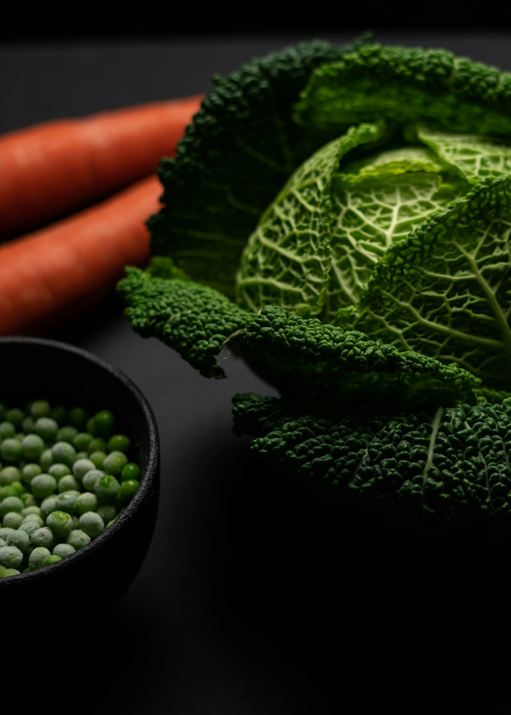 green vegetable beside black bowl