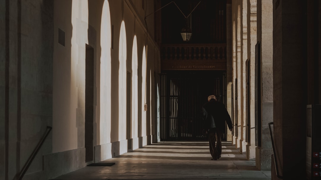 man walking in hallway at daytime