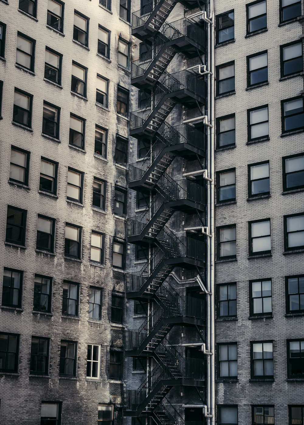 gray concrete buildings with metal exit stairs