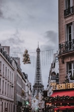 view of Eiffel tower in between concrete buildings at daytime