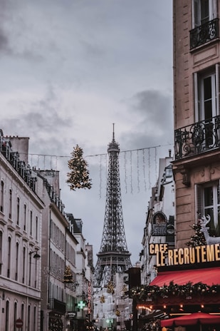 view of Eiffel tower in between concrete buildings at daytime