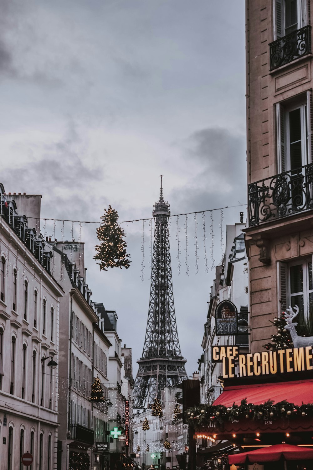 view of Eiffel tower in between concrete buildings at daytime