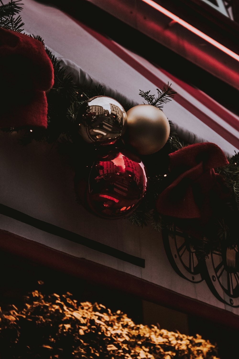 selective focus photography of silver, gold and red baubles