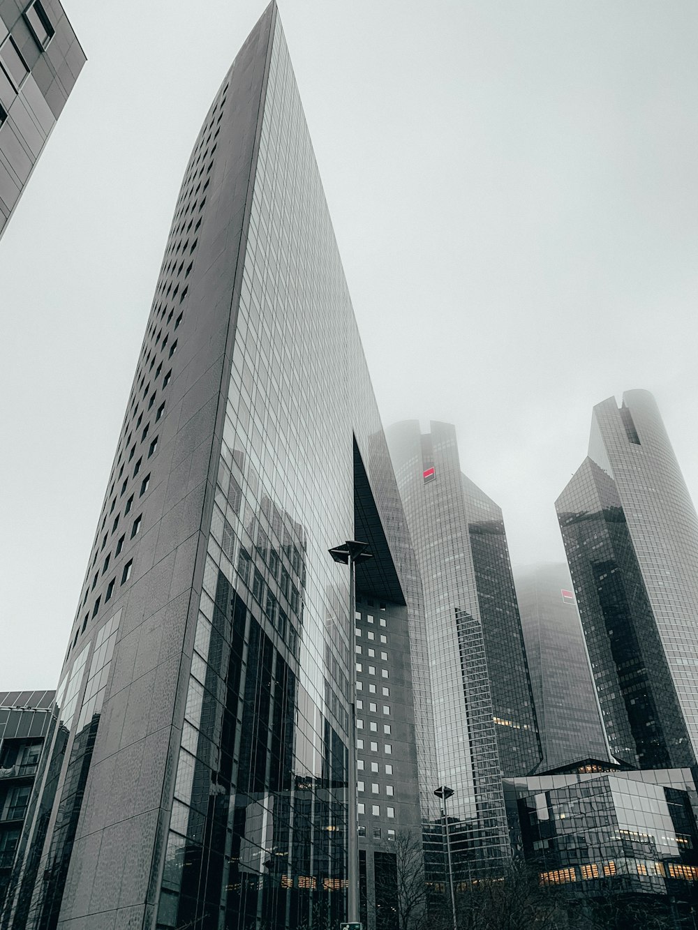 grey glass paneled triangular shaped high-rise building