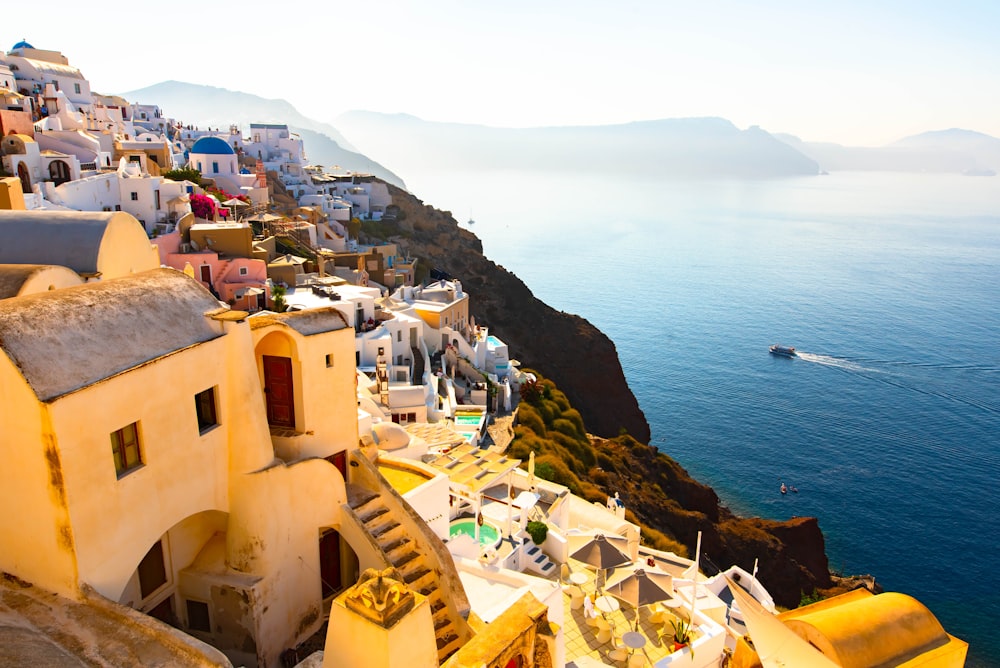 white and brown village on mountain fronting ocean