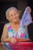 woman wearing white and pink floral tank dress holding purple textile