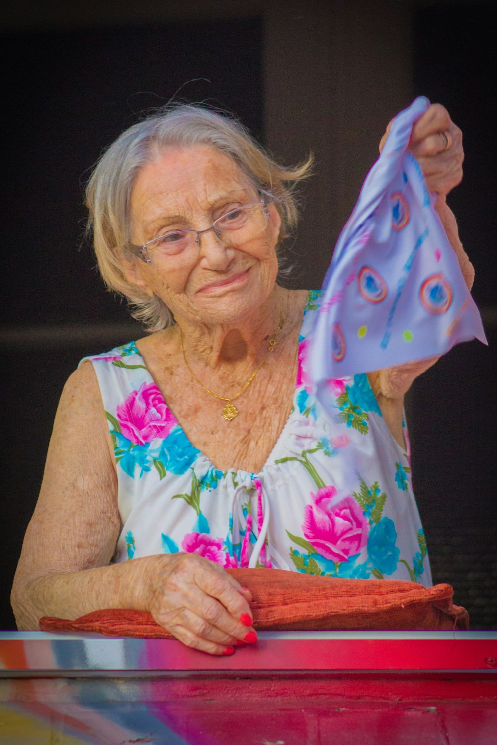 woman wearing white and pink floral tank dress holding purple textile