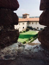 View of the hotel’s charming courtyard with antique stone walls and greenery.