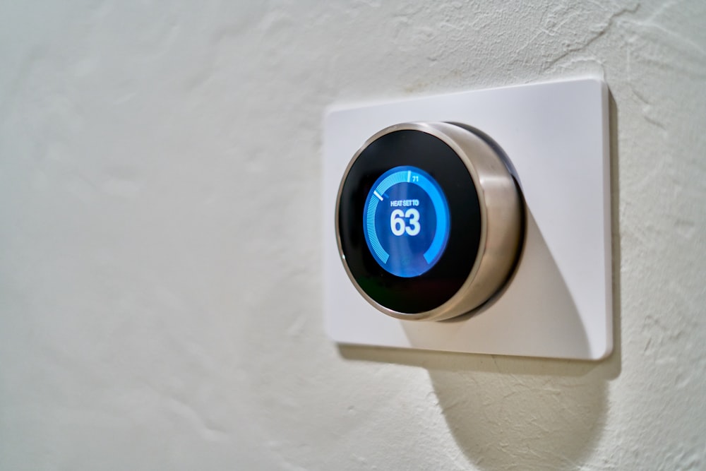 Gray Nest Thermostat Displaying At 63