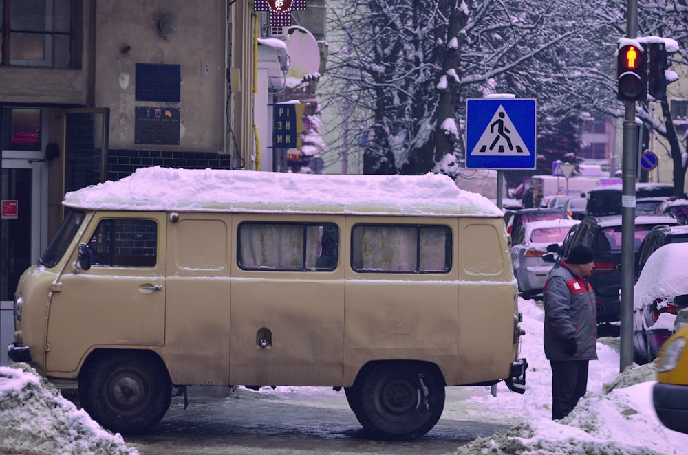 roof of a van covered with snow parked beside the road during winter