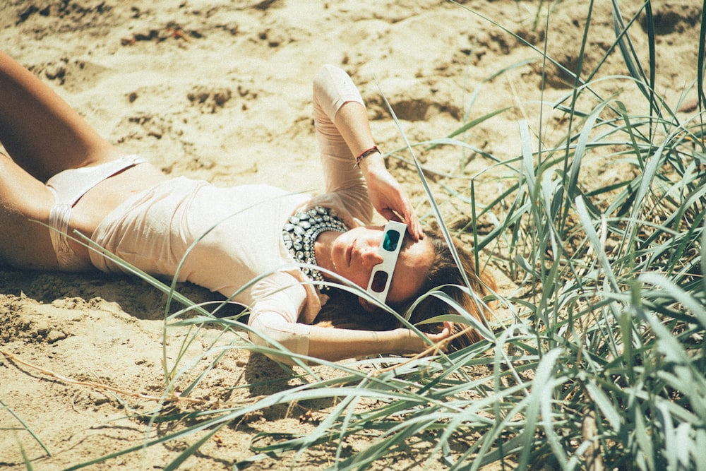 woman lying near green grass