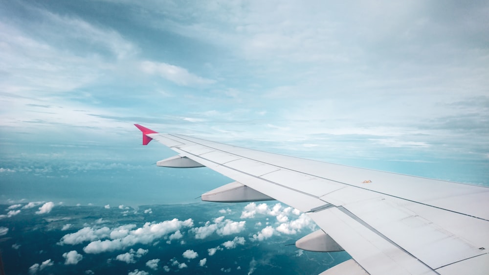 plane flying over white clouds formation