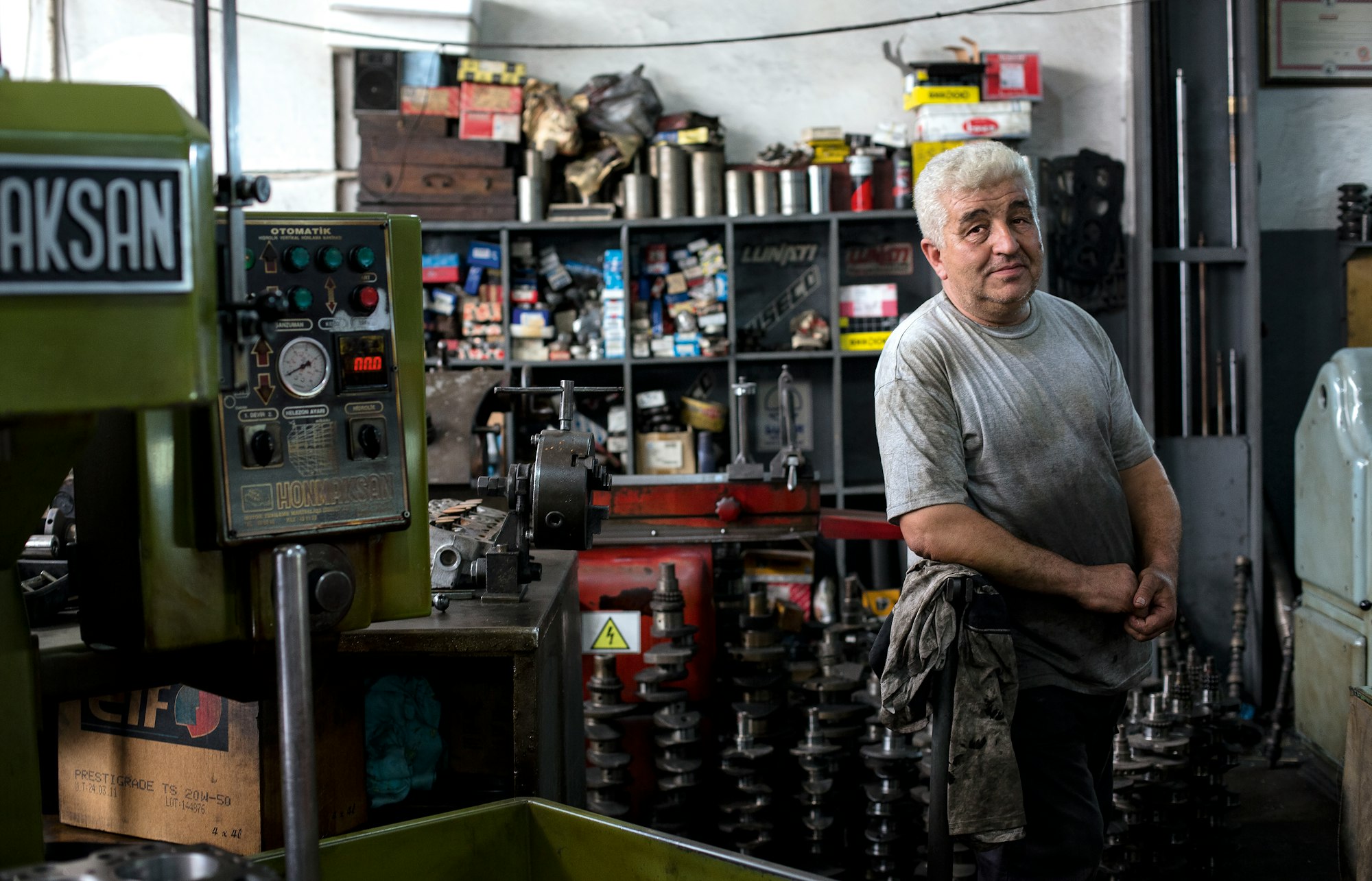 small local business, an older man, owner of the shop, looking at the photo