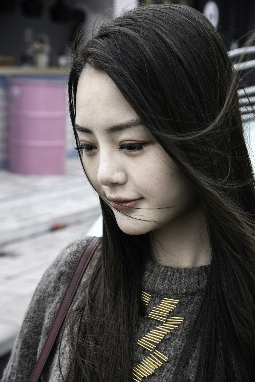 smiling woman in grey knit sweater