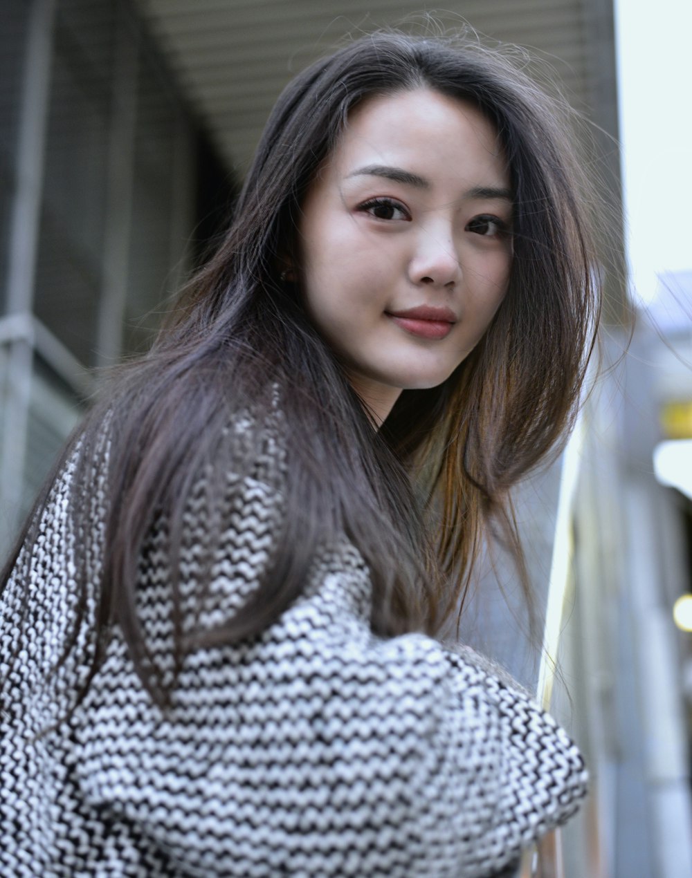 woman standing beside stair rail