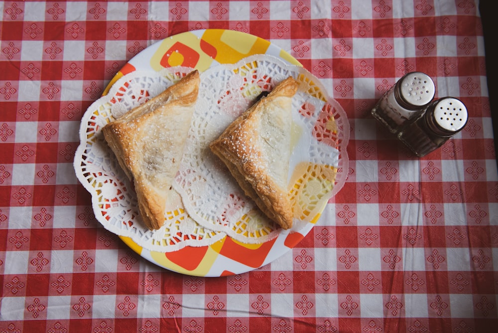 toasted bread on plate near salt and pepper shakers