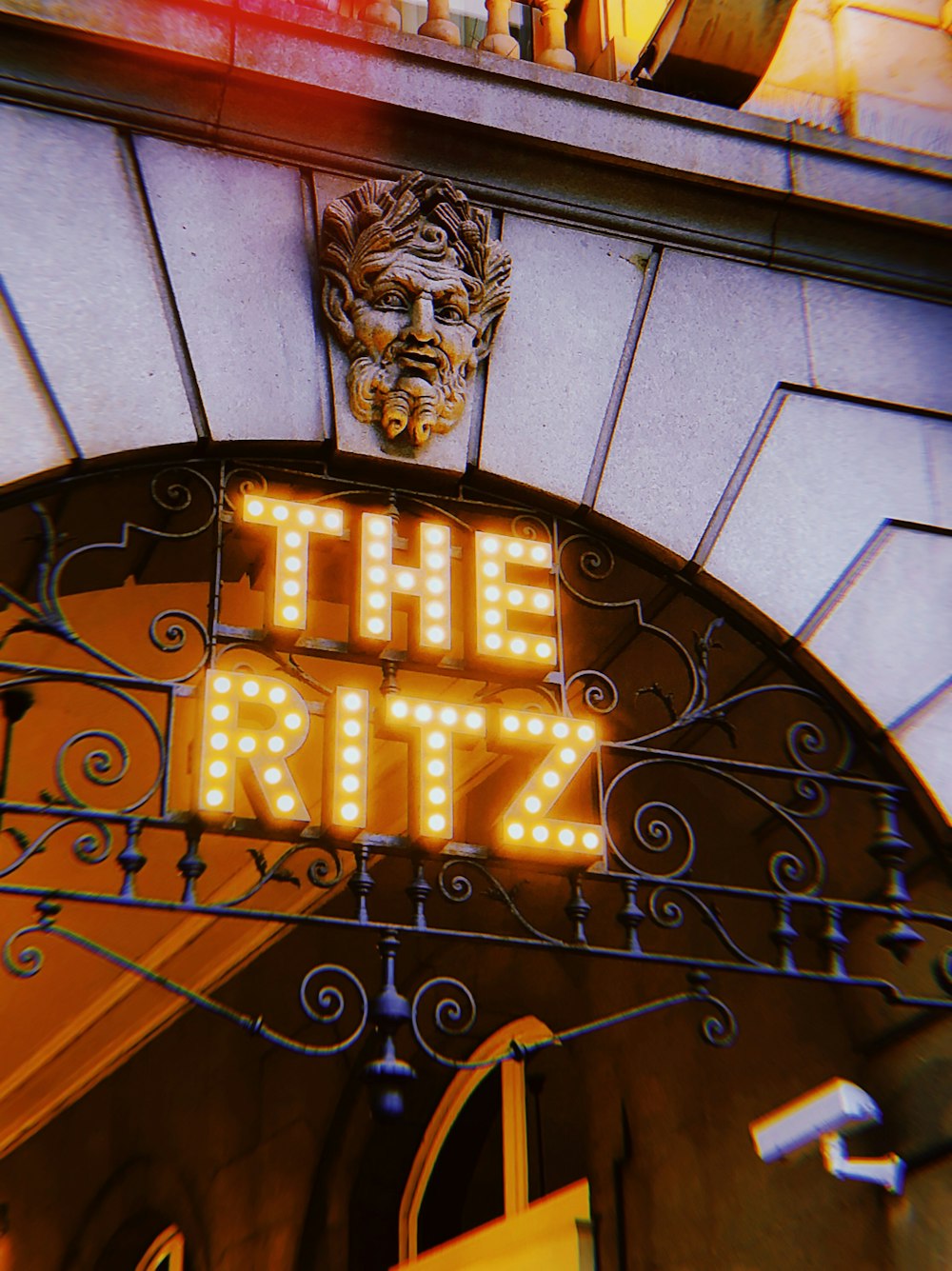 yellow and white The Ritz neon light