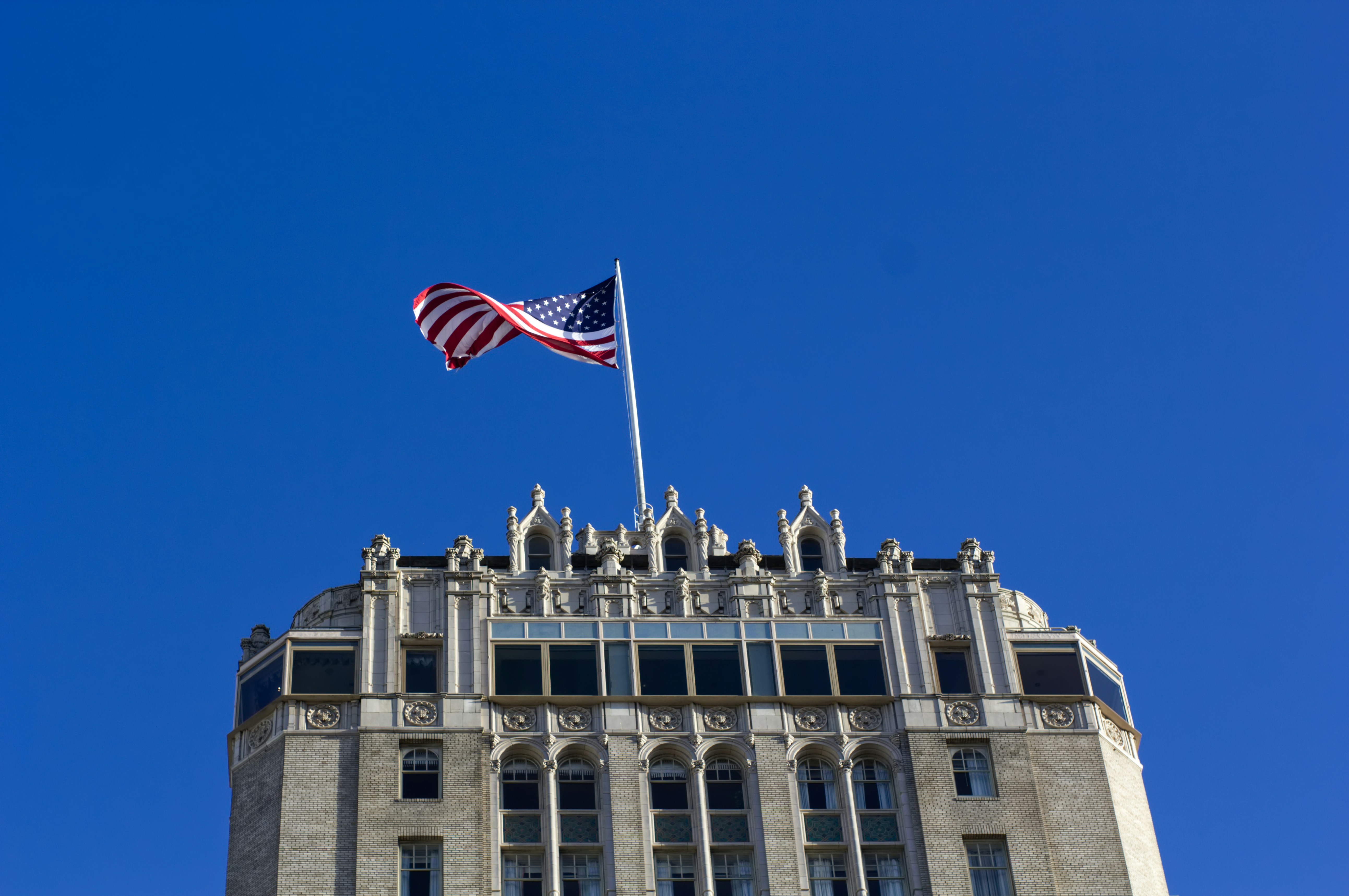 USA flag on pole on top of building