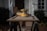 A yellow and black electric sander rests on a wooden cabinet door placed on a pair of sawhorses. The background features a blurred house exterior with a plant, conveying a home improvement setting.