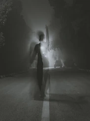 man standing at middle of road