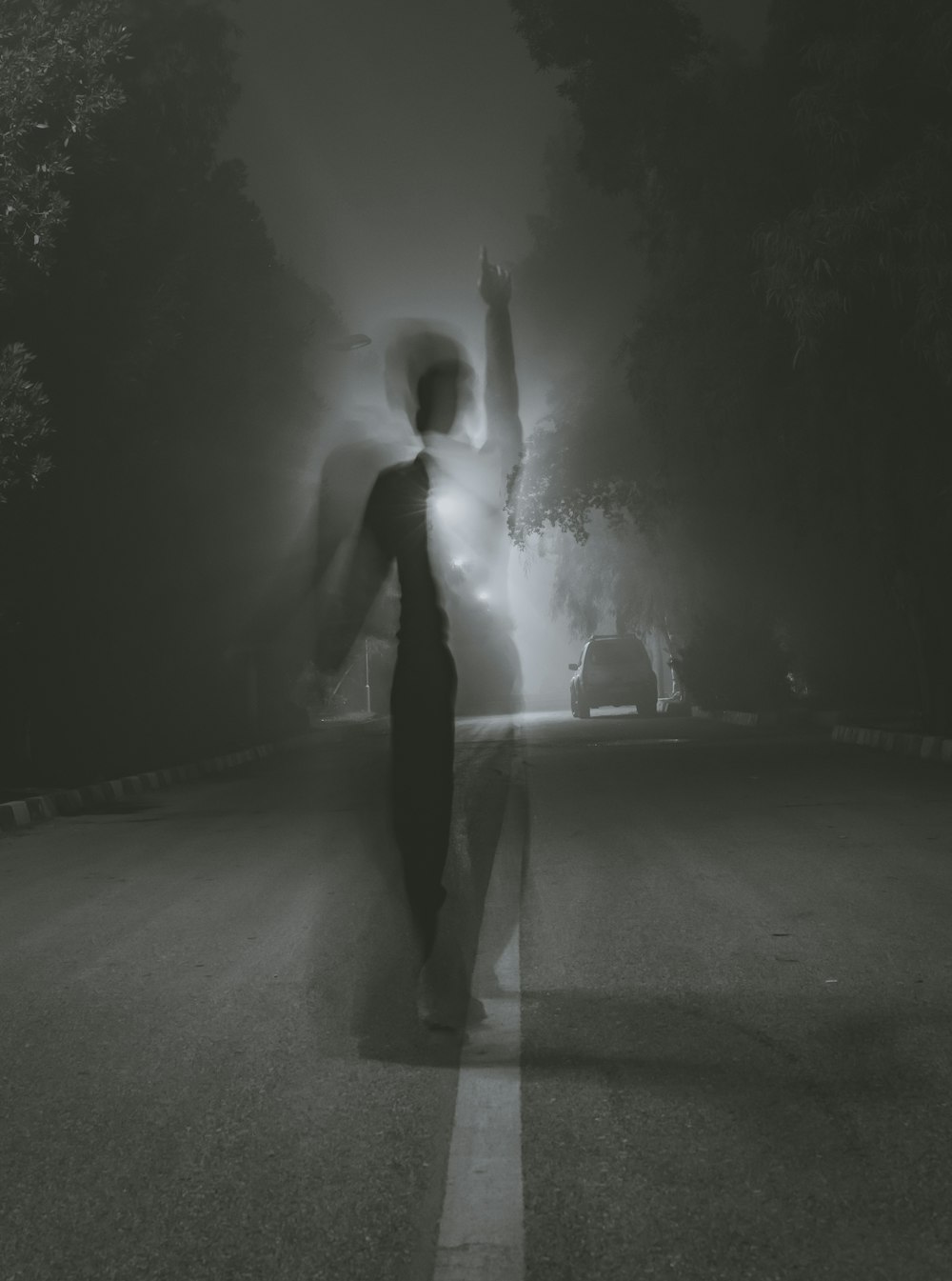 man standing at middle of road