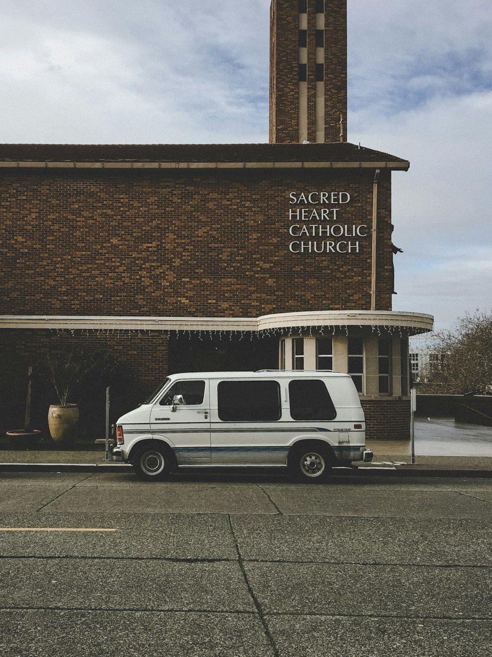 white custom van parked in front of church