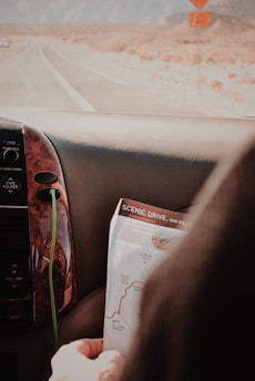 Traveler reading a map with Antelope Canyon's entrance in the background.