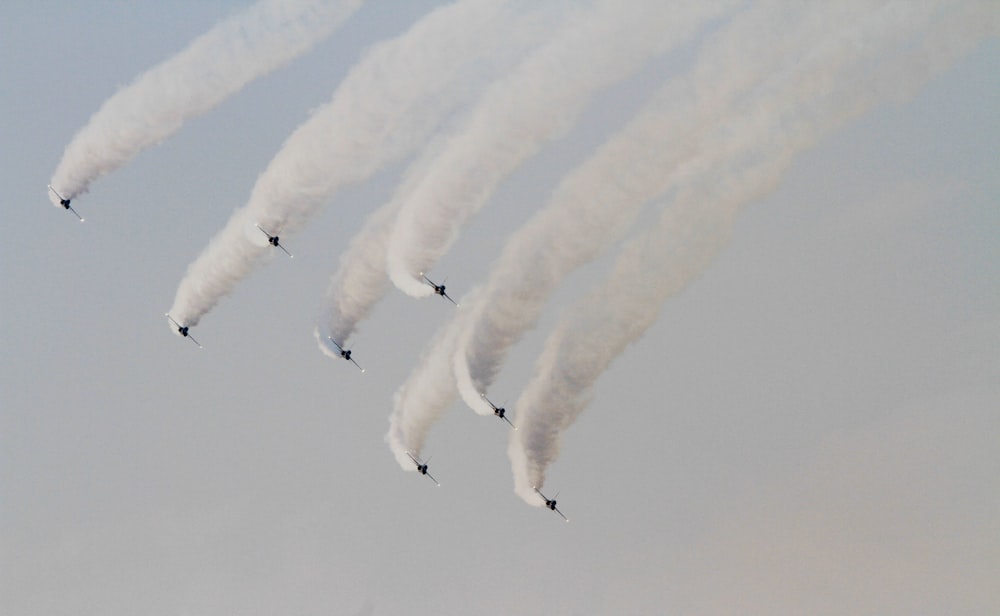 eight smoke trails during daytime