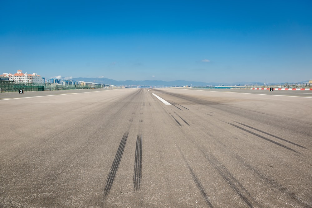 wheel marks on gray concrete pavement during daytime