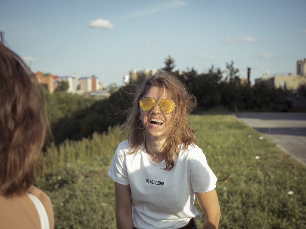 woman standing on grass field during daaytime