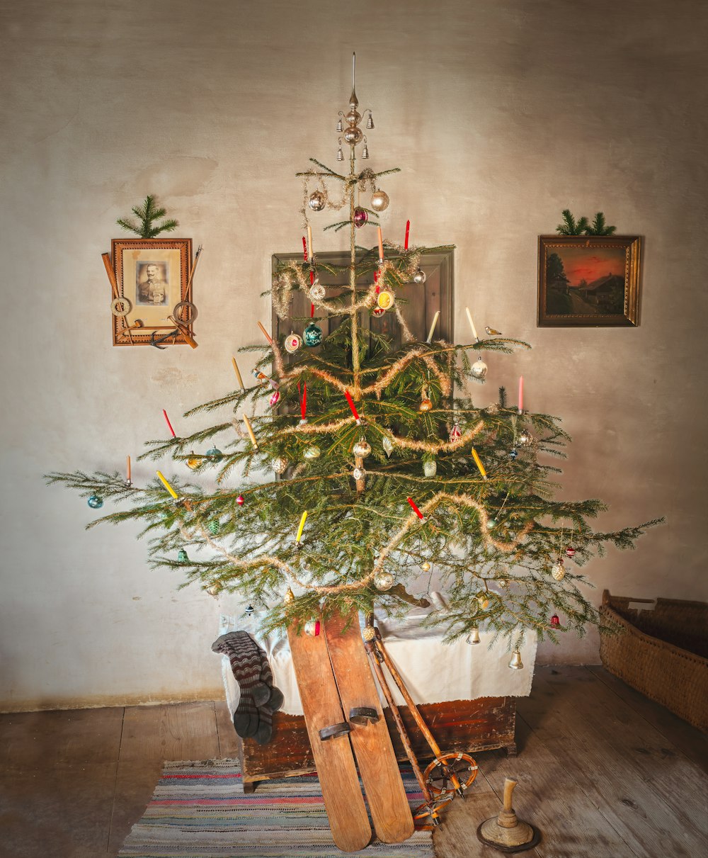 green Christmas tree and pair of brown snow skis