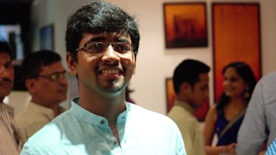 Portrait of Nilesh Bobade engaging warmly with local community members at a neighborhood event.