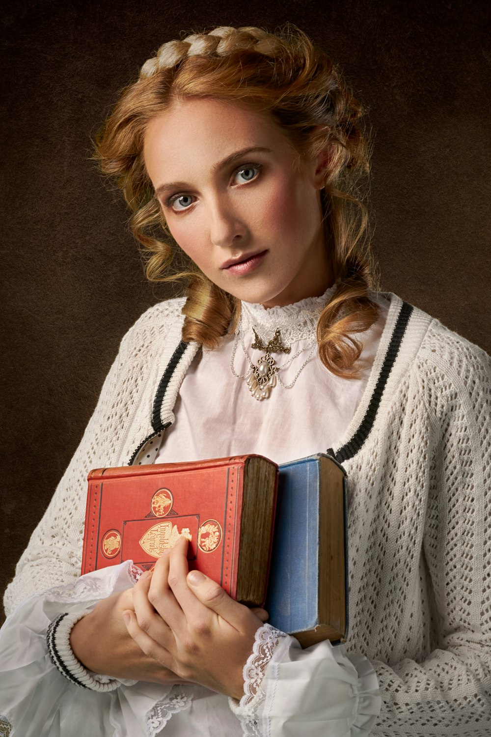 woman holding two books