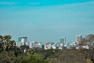 Cityscape of Davao City with modern buildings and tropical greenery.