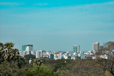 Cityscape of Davao City with modern buildings and tropical greenery.