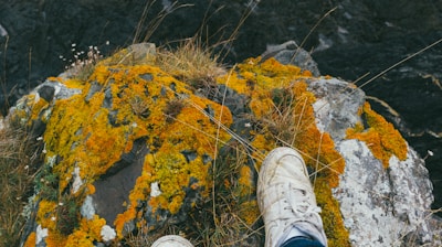 person sitting on rock during daytime