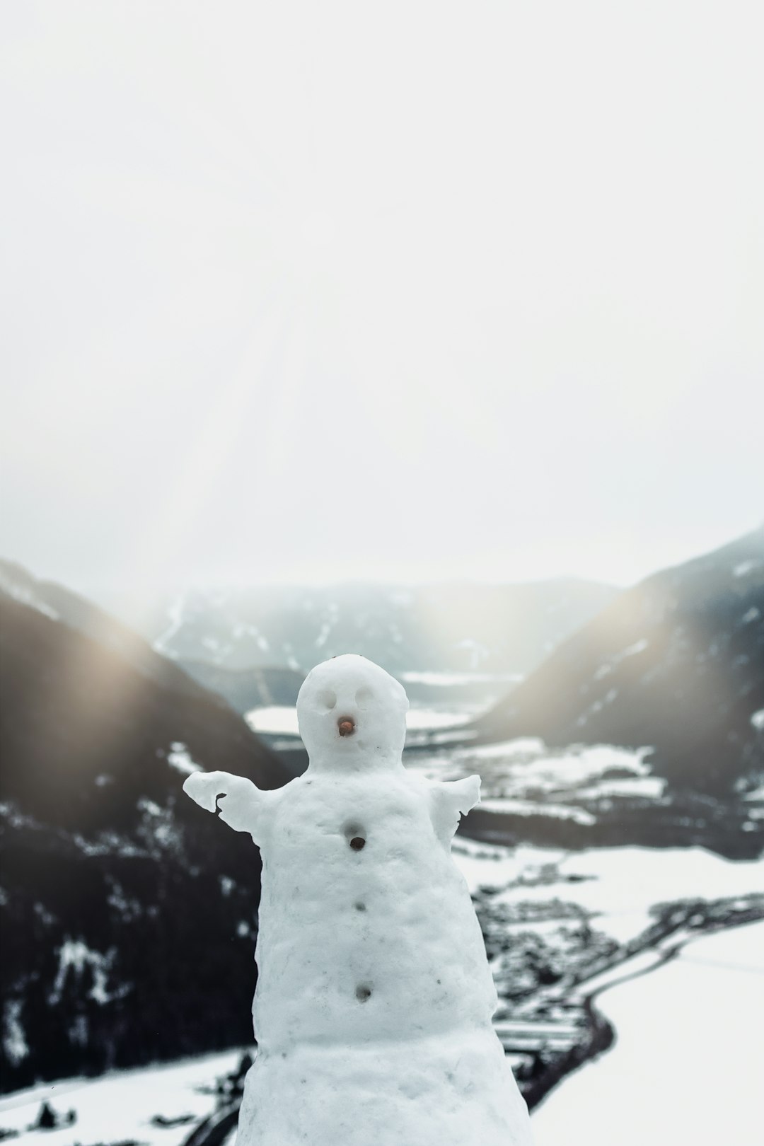 white snowman on side of hill