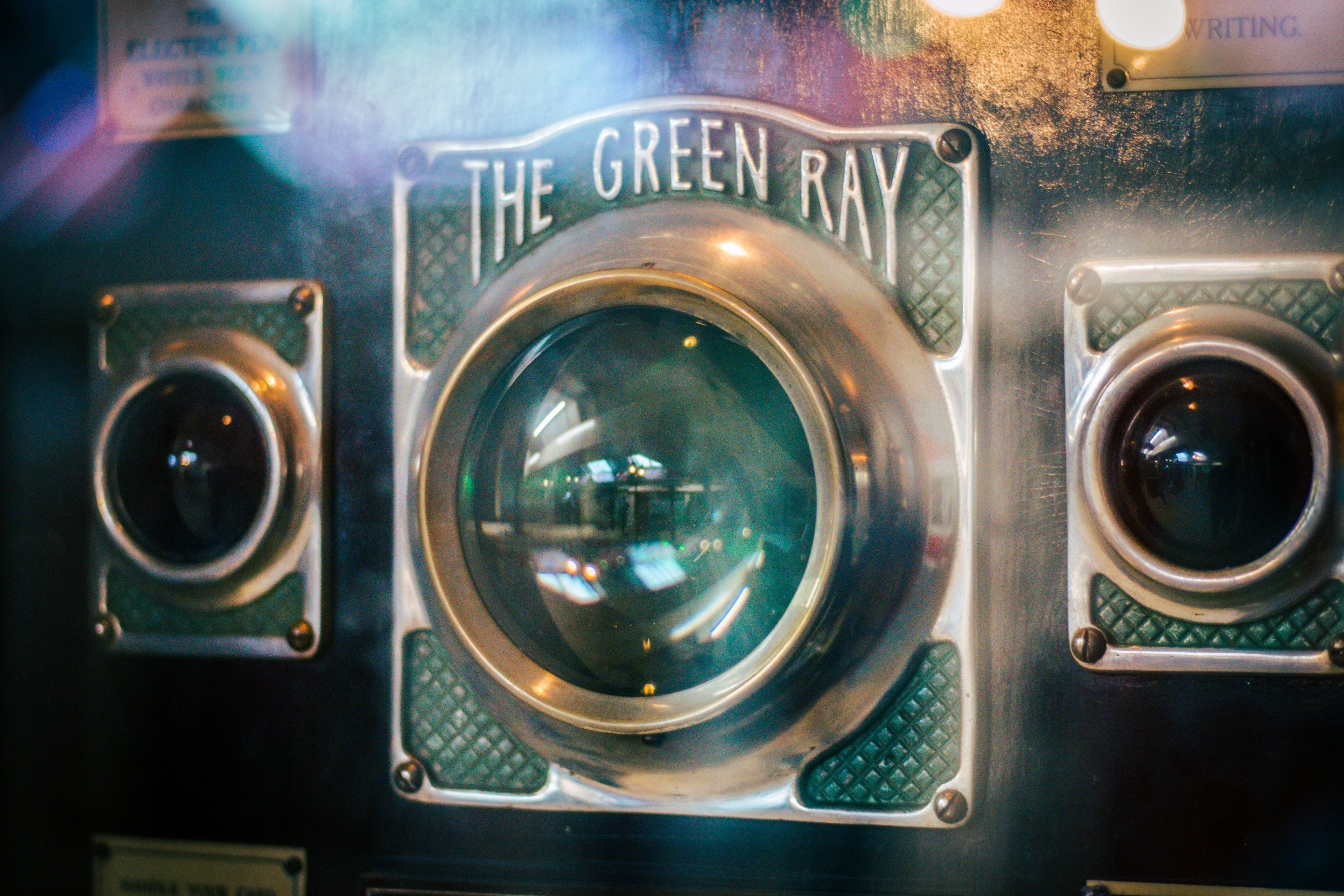 green and brass-colored The Green Ray machine