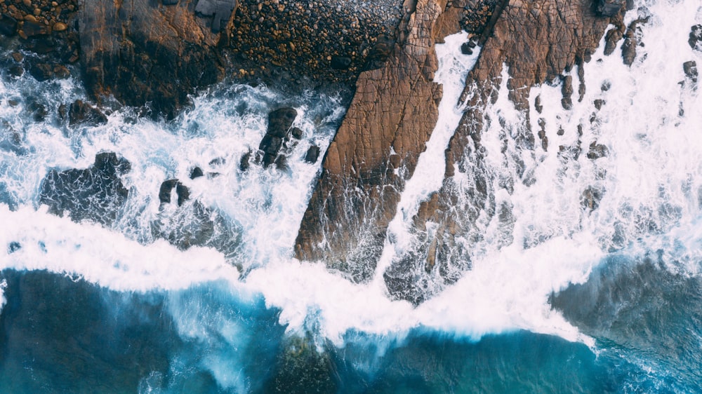 brown rocks on body of water