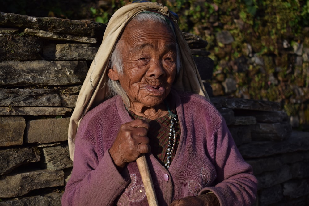 woman holding brown stick