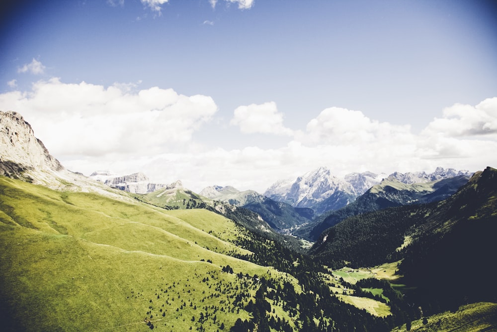 landscape photo of mountains under cloudy sky