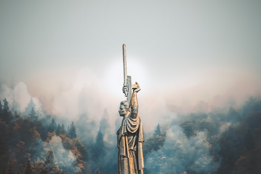 person standing on cliff painting