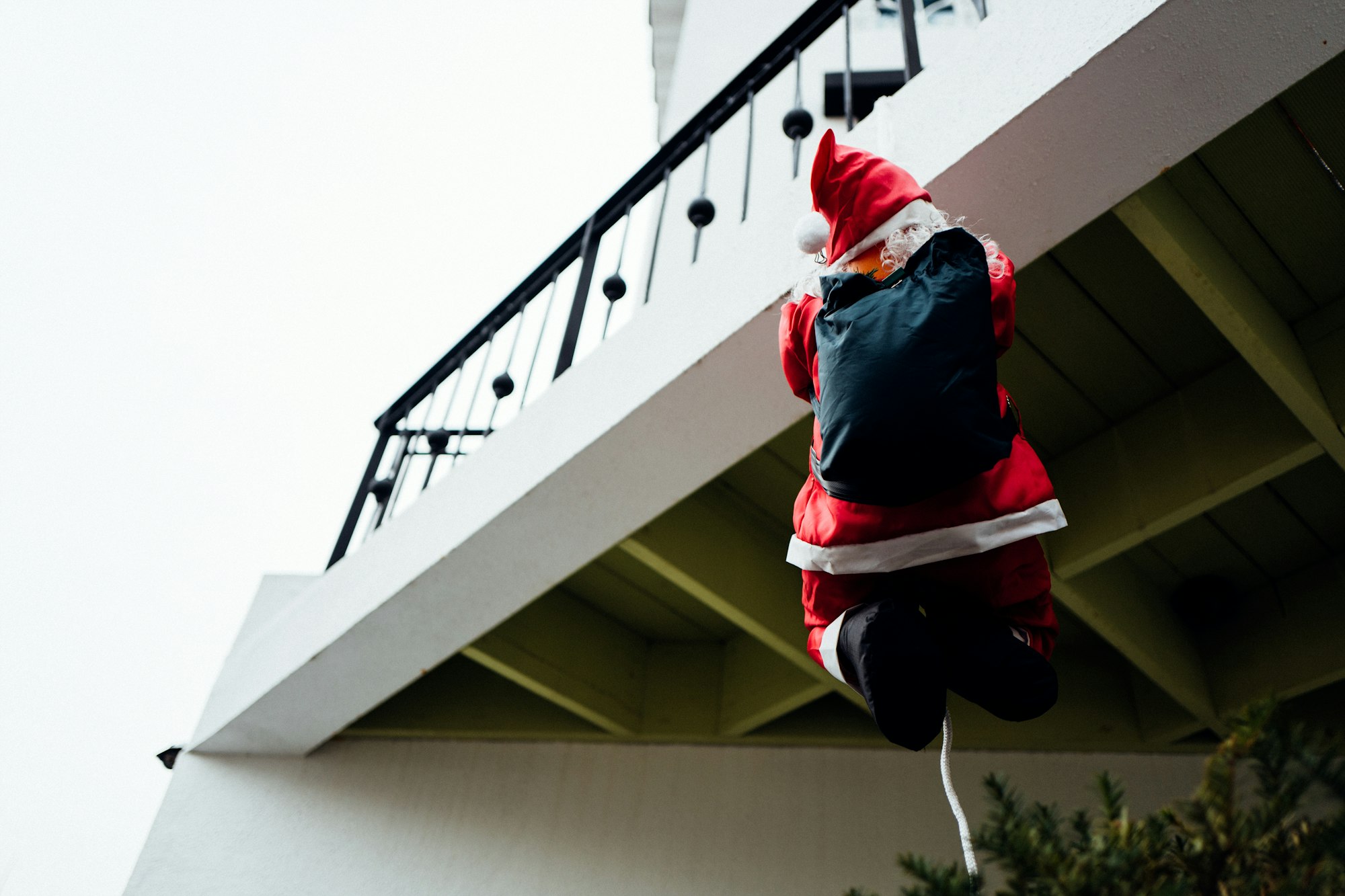 Santa climbing an apartment building. 