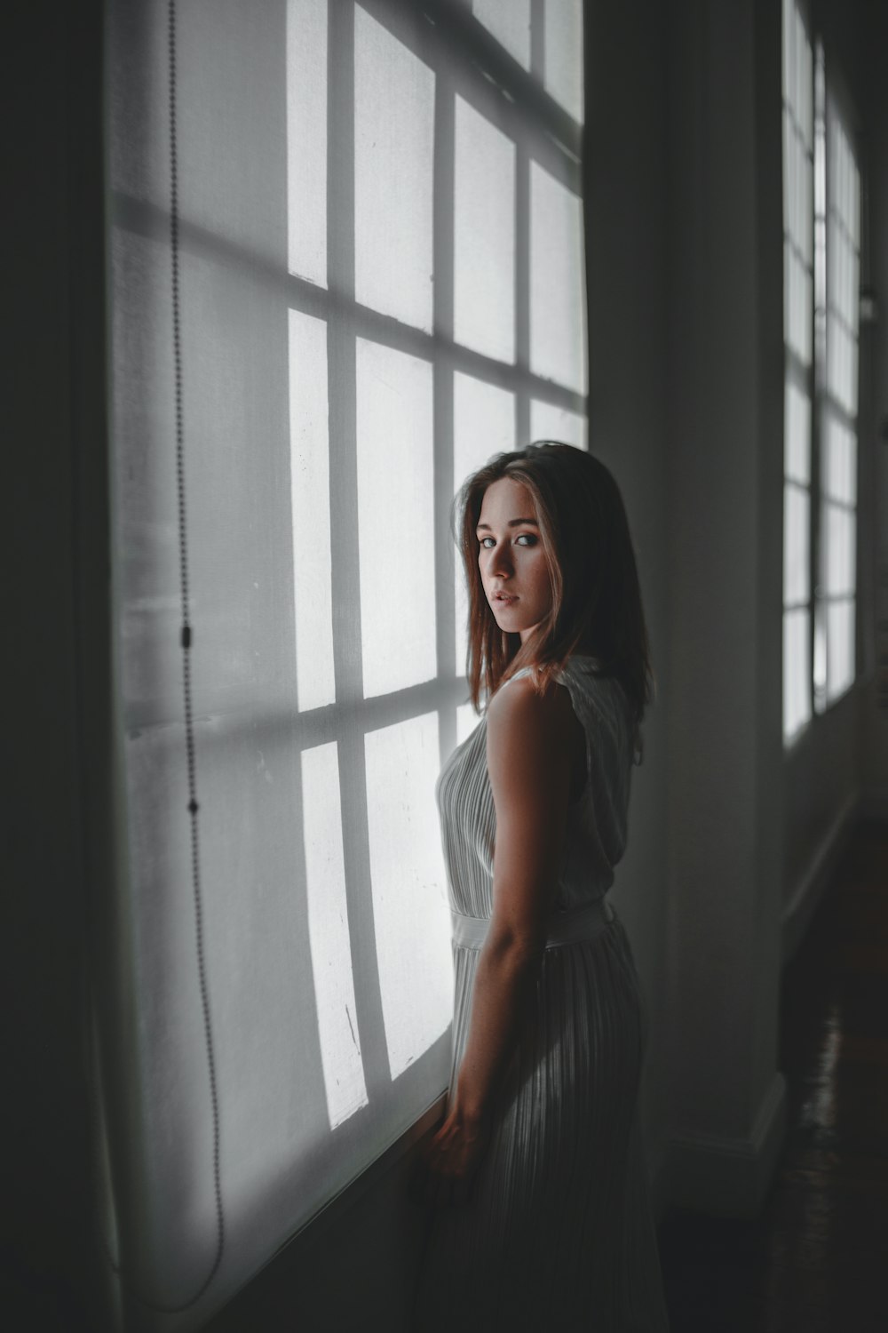 woman standing near window