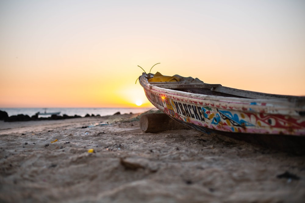 multicolored boat on brown sand
